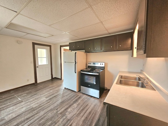 324 Holcombe Ave, Litchfield, MN 55355 - kitchen with electric range, freestanding refrigerator, a paneled ceiling, light countertops, and wood finished floors