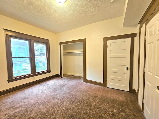 324 Holcombe Ave, Litchfield, MN 55355 - unfurnished bedroom with carpet floors, a textured ceiling, and a closet