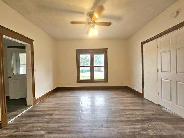 324 Holcombe Ave, Litchfield, MN 55355 - unfurnished room with dark wood finished floors, a ceiling fan, and a textured ceiling