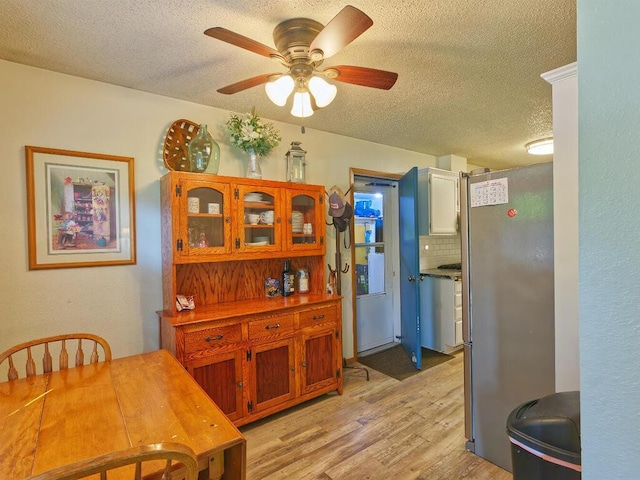 638 Shady Creek Cir, Winsted, MN 55395 - dining area with a textured ceiling, light wood-style floors, and a ceiling fan