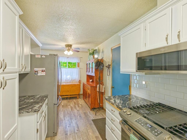 638 Shady Creek Cir, Winsted, MN 55395 - kitchen featuring appliances with stainless steel finishes, a textured ceiling, light wood-style floors, white cabinetry, and a ceiling fan