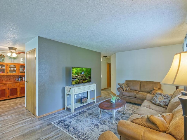 638 Shady Creek Cir, Winsted, MN 55395 - living area with a textured ceiling, wood finished floors, and ceiling fan