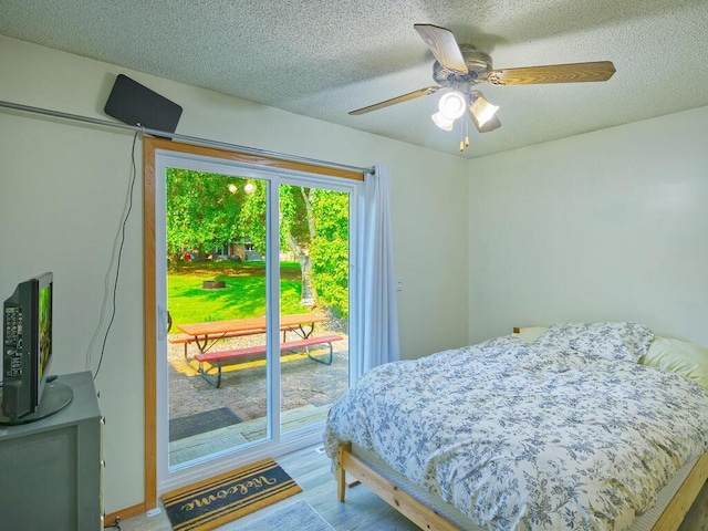 638 Shady Creek Cir, Winsted, MN 55395 - bedroom featuring access to outside, wood finished floors, a textured ceiling, and a ceiling fan