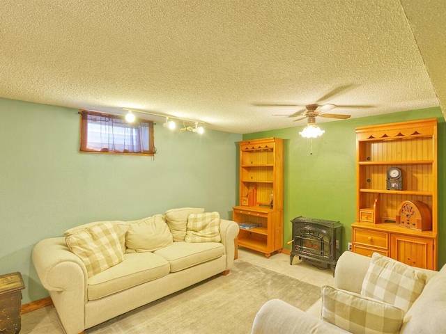 638 Shady Creek Cir, Winsted, MN 55395 - living area featuring a wood stove, rail lighting, ceiling fan, and a textured ceiling