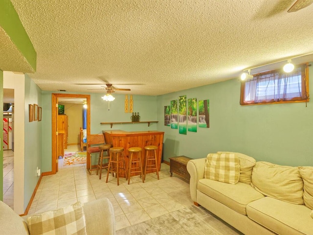 638 Shady Creek Cir, Winsted, MN 55395 - living area featuring a dry bar, a textured ceiling, light tile patterned flooring, and ceiling fan