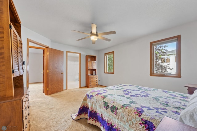 3306 26th Ave S, Fargo, ND 58103 - bedroom featuring light carpet, ceiling fan, and ensuite bath