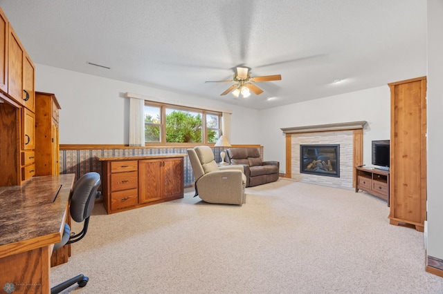 3306 26th Ave S, Fargo, ND 58103 - carpeted living room with a ceiling fan, a glass covered fireplace, and a textured ceiling
