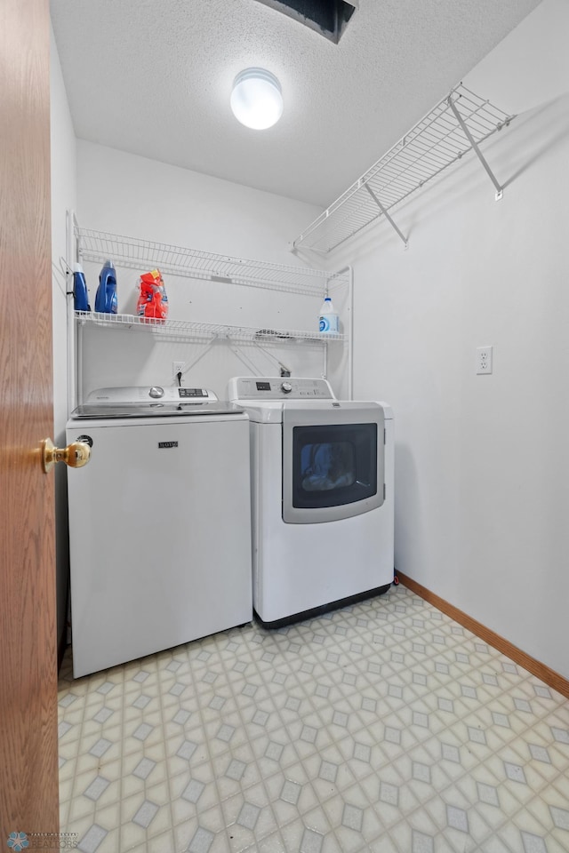 3306 26th Ave S, Fargo, ND 58103 - washroom featuring washing machine and clothes dryer, light floors, and a textured ceiling