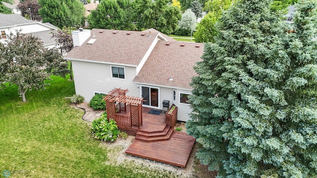 3306 26th Ave S, Fargo, ND 58103 - rear view of property with a deck, roof with shingles, a lawn, and a chimney