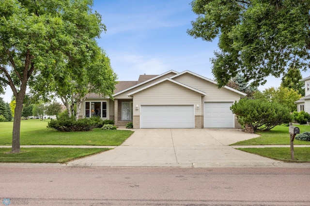 3306 26th Ave S, Fargo, ND 58103 - ranch-style house featuring an attached garage, driveway, a front lawn, and brick siding