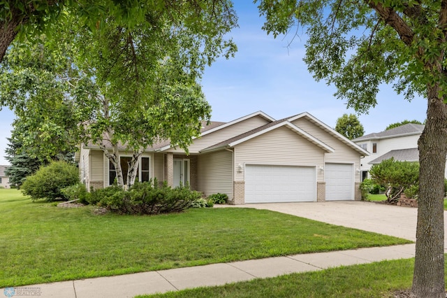 3306 26th Ave S, Fargo, ND 58103 - view of front of home with a garage, driveway, a front yard, and brick siding