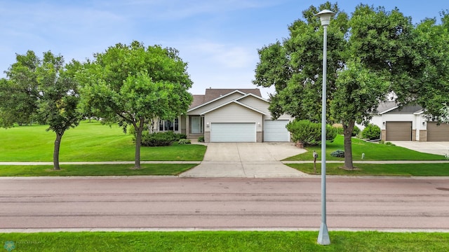 3306 26th Ave S, Fargo, ND 58103 - view of front of house featuring a front lawn, a garage, driveway, and brick siding
