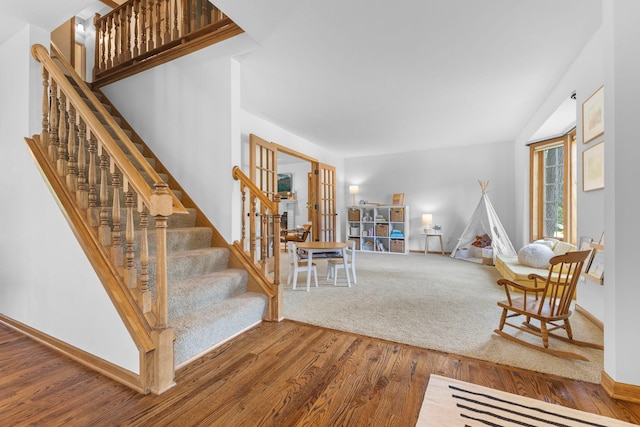 13870 Daphne Ln, Rosemount, MN 55068 - living area with wood finished floors, french doors, stairs, and baseboards
