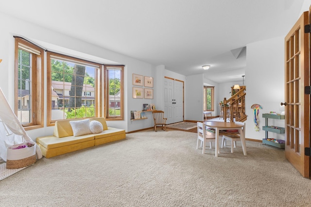 13870 Daphne Ln, Rosemount, MN 55068 - living area featuring healthy amount of natural light, light carpet, and baseboards