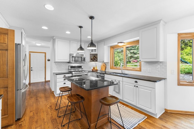 13870 Daphne Ln, Rosemount, MN 55068 - kitchen with appliances with stainless steel finishes, a sink, wood finished floors, white cabinets, and recessed lighting