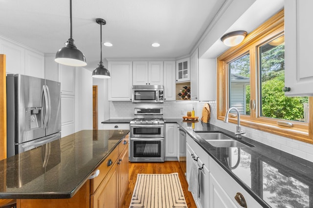 13870 Daphne Ln, Rosemount, MN 55068 - kitchen featuring appliances with stainless steel finishes, a sink, healthy amount of natural light, white cabinets, and recessed lighting