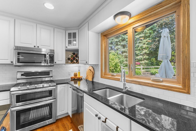 13870 Daphne Ln, Rosemount, MN 55068 - kitchen with appliances with stainless steel finishes, a sink, white cabinetry, and backsplash