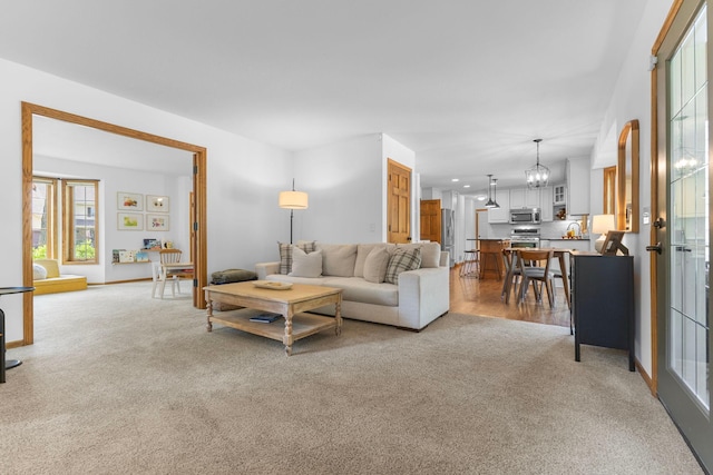 13870 Daphne Ln, Rosemount, MN 55068 - living area with light colored carpet, a chandelier, and baseboards