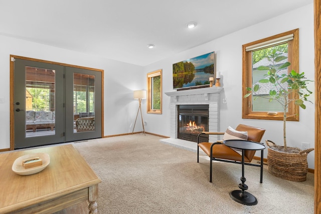 13870 Daphne Ln, Rosemount, MN 55068 - carpeted living area with plenty of natural light, a brick fireplace, baseboards, and french doors