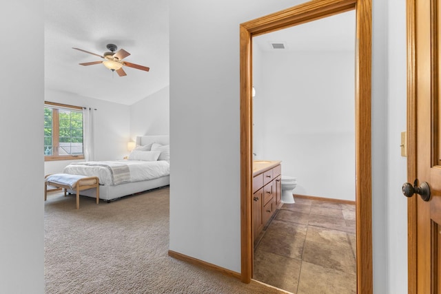 13870 Daphne Ln, Rosemount, MN 55068 - bedroom featuring baseboards, vaulted ceiling, connected bathroom, light colored carpet, and ceiling fan
