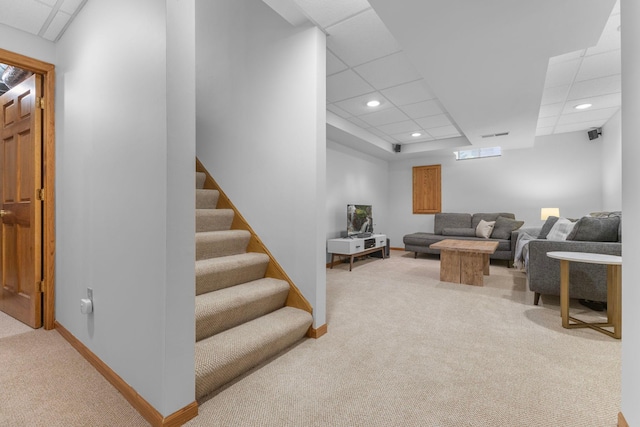 13870 Daphne Ln, Rosemount, MN 55068 - living room with light colored carpet, baseboards, a paneled ceiling, recessed lighting, and stairs