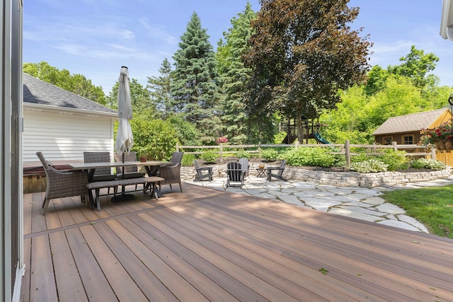 13870 Daphne Ln, Rosemount, MN 55068 - wooden deck with outdoor dining space, a playground, and view of scattered trees