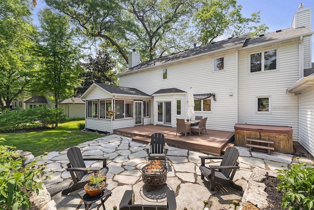 13870 Daphne Ln, Rosemount, MN 55068 - rear view of house with an outdoor fire pit, a hot tub, a sunroom, a patio area, and a deck