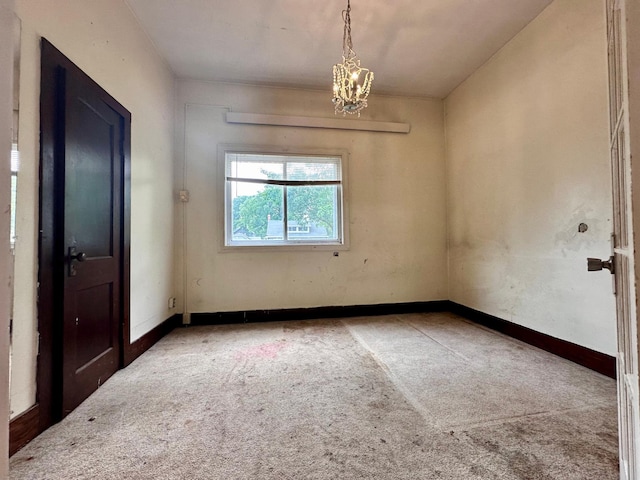 506 Marshall St, Marshall, MN 56258 - empty room featuring carpet floors, a chandelier, and baseboards