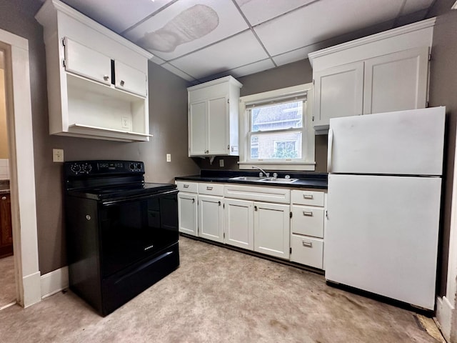 506 Marshall St, Marshall, MN 56258 - kitchen with freestanding refrigerator, black range with electric cooktop, a sink, dark countertops, and white cabinetry