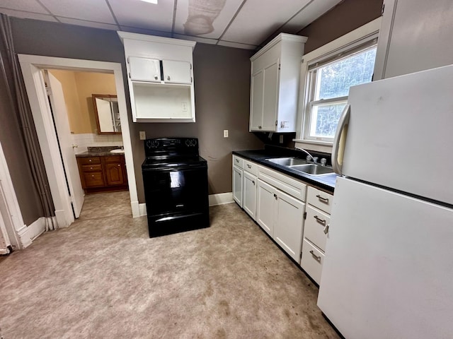 506 Marshall St, Marshall, MN 56258 - kitchen featuring freestanding refrigerator, electric range, a drop ceiling, a sink, and light carpet