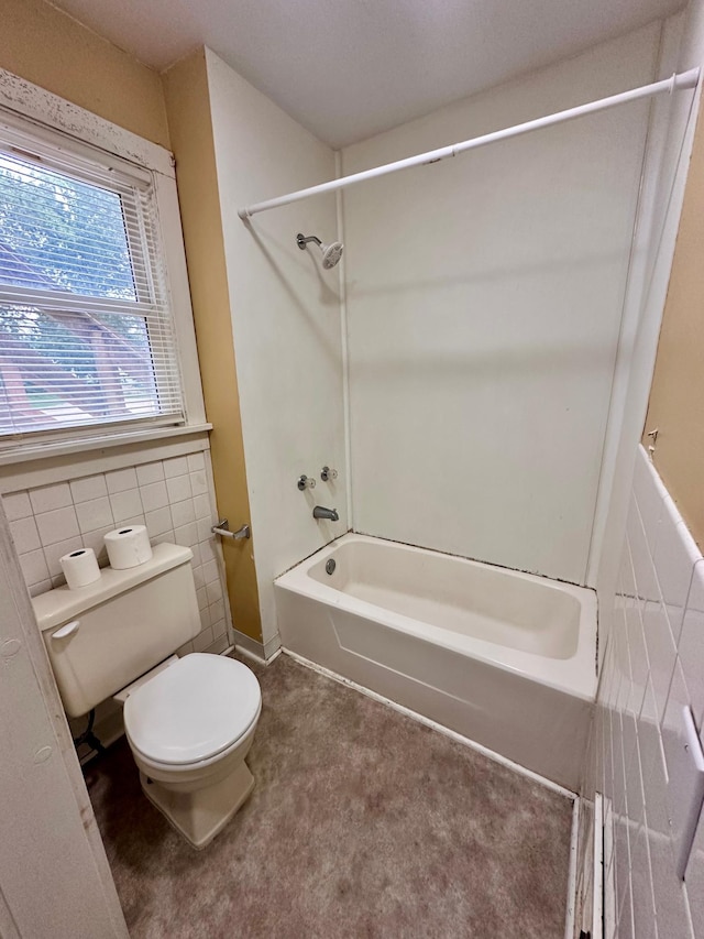 506 Marshall St, Marshall, MN 56258 - bathroom featuring toilet, bathing tub / shower combination, and tile walls