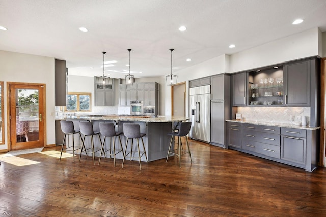 10481 Bluff Rd, Eden Prairie, MN 55347 - kitchen with stainless steel appliances, gray cabinets, recessed lighting, decorative backsplash, and glass insert cabinets