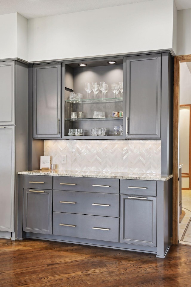10481 Bluff Rd, Eden Prairie, MN 55347 - indoor dry bar with backsplash and dark wood-style flooring