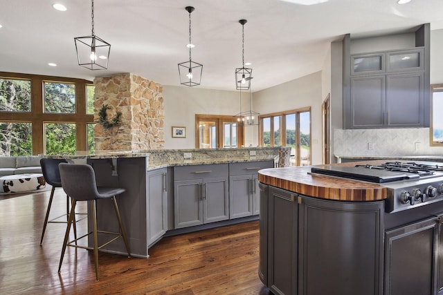 10481 Bluff Rd, Eden Prairie, MN 55347 - kitchen with butcher block counters, a center island, gray cabinets, plenty of natural light, and recessed lighting