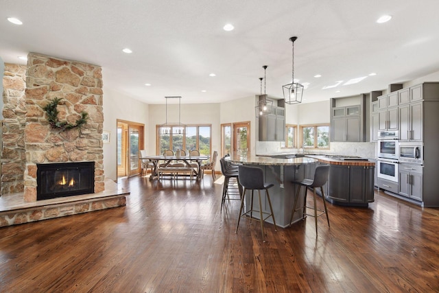 10481 Bluff Rd, Eden Prairie, MN 55347 - kitchen with gray cabinets, stainless steel appliances, dark wood-style flooring, backsplash, and recessed lighting