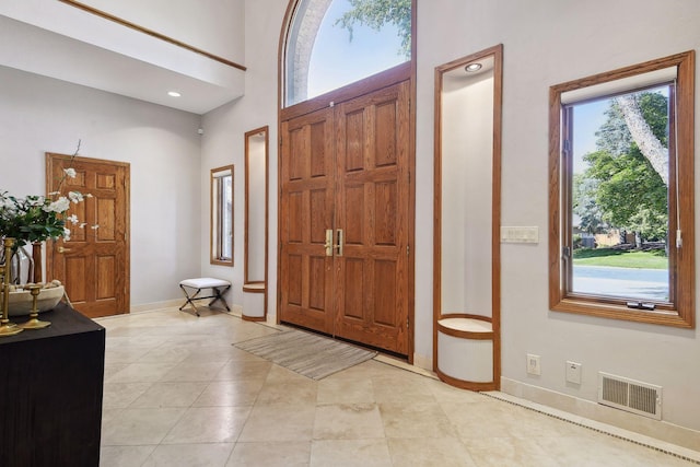 10481 Bluff Rd, Eden Prairie, MN 55347 - foyer with light tile patterned floors and a towering ceiling