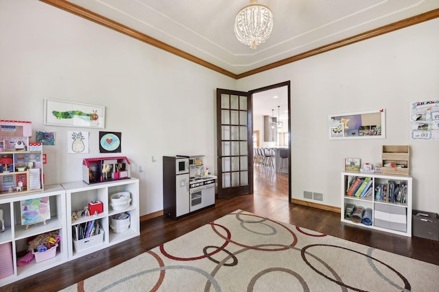 10481 Bluff Rd, Eden Prairie, MN 55347 - playroom featuring a chandelier, ornamental molding, and wood finished floors
