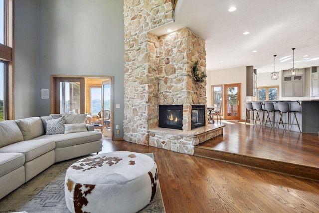 10481 Bluff Rd, Eden Prairie, MN 55347 - living room featuring wood finished floors, a fireplace, recessed lighting, and a high ceiling