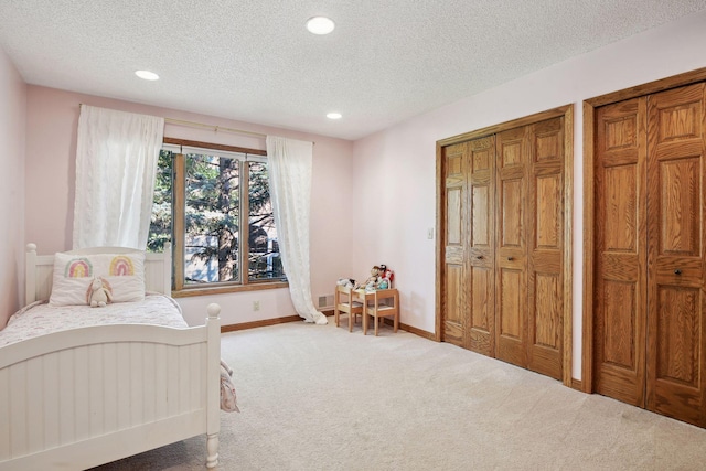 10481 Bluff Rd, Eden Prairie, MN 55347 - carpeted bedroom with multiple closets, a textured ceiling, and recessed lighting