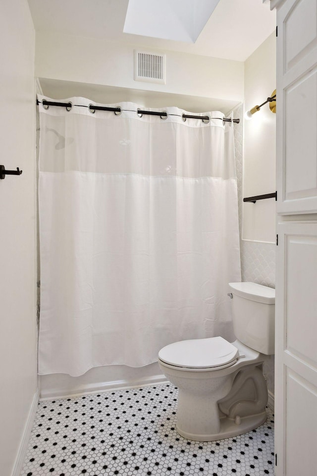 10481 Bluff Rd, Eden Prairie, MN 55347 - bathroom featuring shower / bath combination with curtain and tile patterned flooring