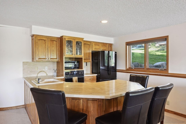 10481 Bluff Rd, Eden Prairie, MN 55347 - kitchen featuring black appliances, light countertops, a peninsula, brown cabinetry, and a textured ceiling