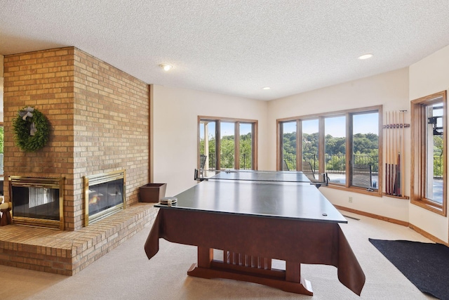 10481 Bluff Rd, Eden Prairie, MN 55347 - playroom with carpet floors, a brick fireplace, a textured ceiling, and recessed lighting