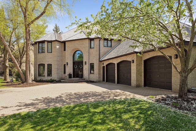 10481 Bluff Rd, Eden Prairie, MN 55347 - view of front of property with brick siding, decorative driveway, a garage, and a high end roof