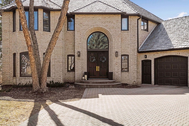 10481 Bluff Rd, Eden Prairie, MN 55347 - entrance to property with a garage, brick siding, and driveway