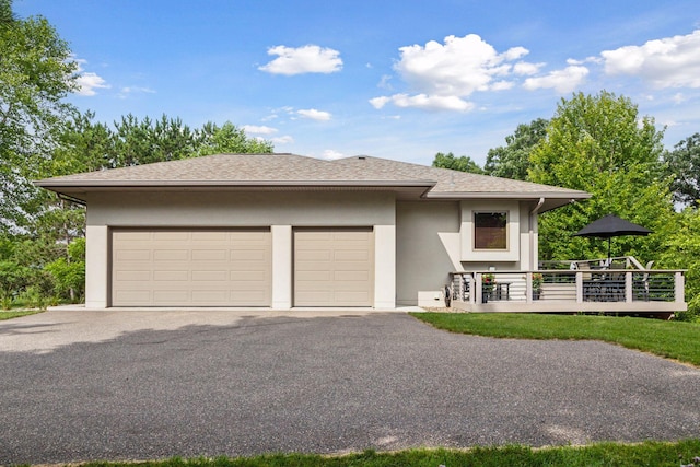 13390 26th St N, West Lakeland Twp, MN 55082 - prairie-style home featuring stucco siding, a deck, a shingled roof, driveway, and a garage