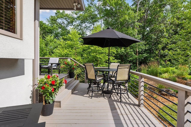 13390 26th St N, West Lakeland Twp, MN 55082 - deck featuring outdoor dining space and view of scattered trees