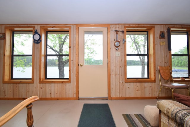 3777 Deer Lake Dr, Danbury, WI 54830 - doorway to outside with wooden walls, plenty of natural light, finished concrete flooring, and a water view