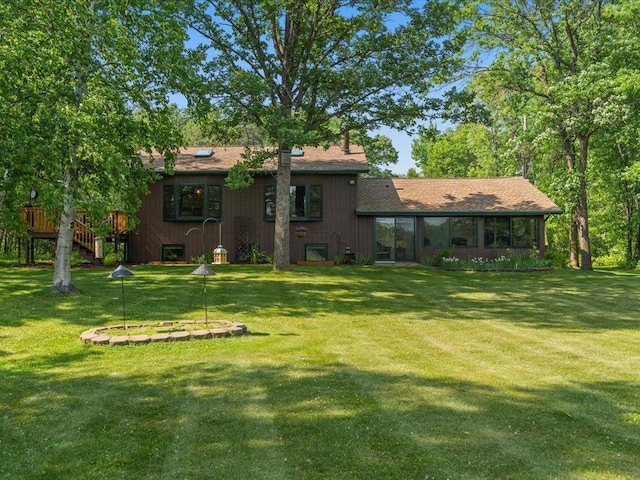 15473 Wilderness Trl, Crosslake, MN 56442 - back of property featuring a yard and a sunroom