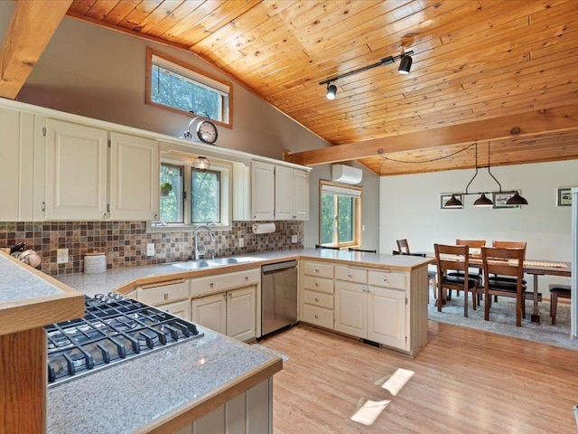 15473 Wilderness Trl, Crosslake, MN 56442 - kitchen with stainless steel appliances, wood ceiling, a peninsula, light countertops, and backsplash