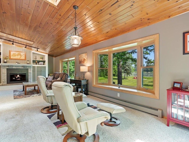 15473 Wilderness Trl, Crosslake, MN 56442 - living area with baseboard heating, wooden ceiling, carpet floors, a brick fireplace, and rail lighting